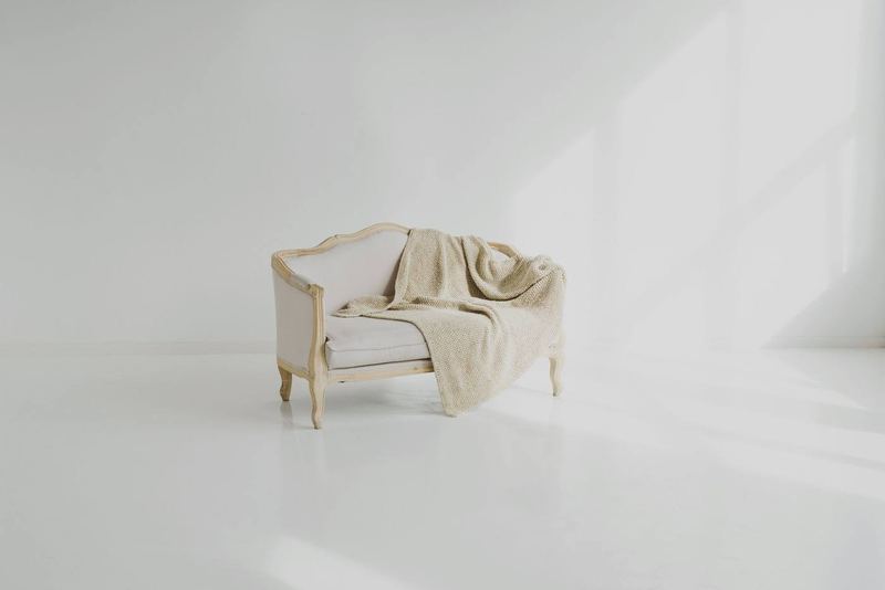 White sofa with a towel